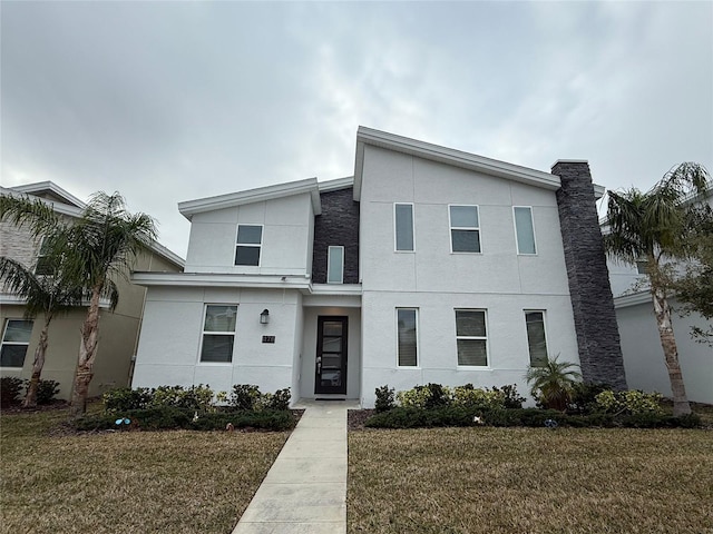 contemporary home with a front lawn