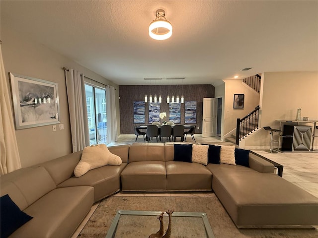 living room with rail lighting and a textured ceiling