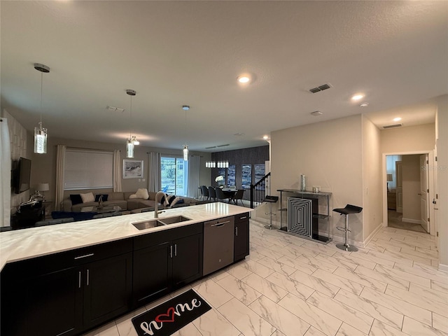 kitchen with sink, decorative light fixtures, and stainless steel dishwasher