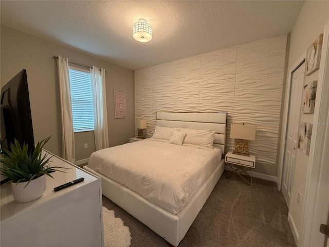 carpeted bedroom with a textured ceiling