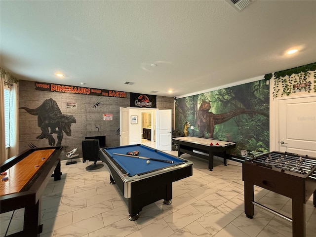 recreation room featuring pool table and a textured ceiling