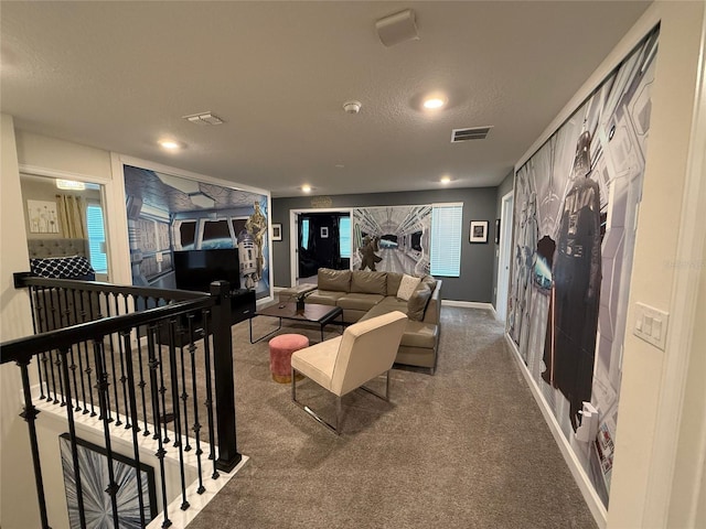 living room featuring carpet floors and a textured ceiling