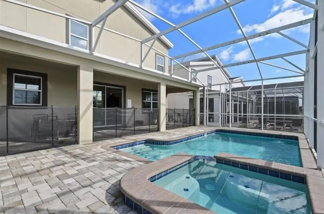 view of pool featuring an in ground hot tub and a patio area