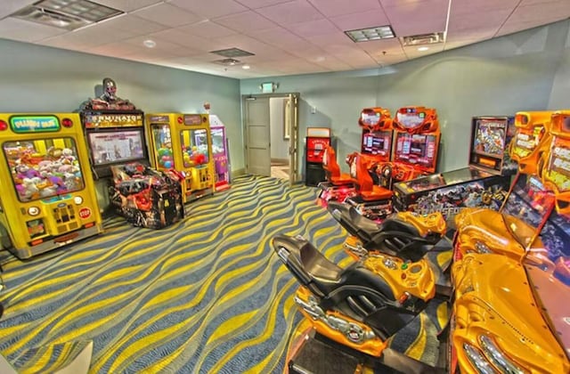 playroom with carpet flooring and a paneled ceiling