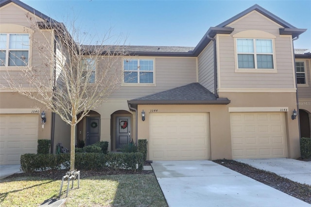 townhome / multi-family property featuring a garage and a front yard