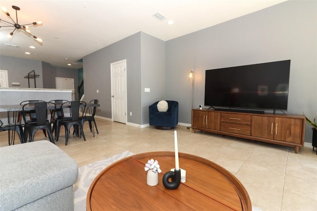 tiled living room featuring a chandelier