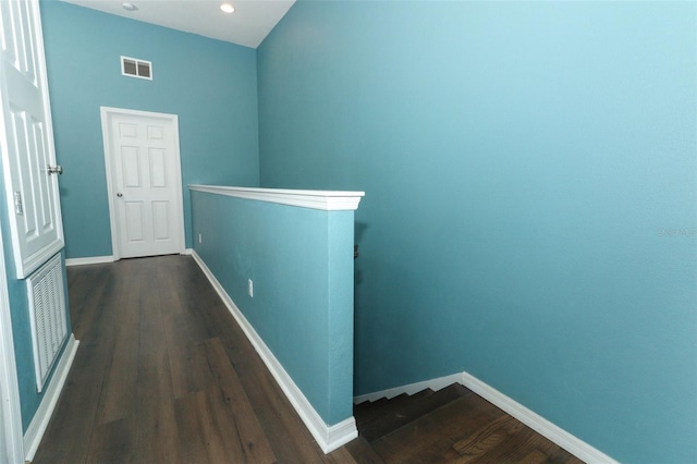 corridor with dark hardwood / wood-style flooring