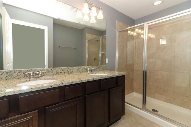 bathroom with vanity, an enclosed shower, and tile patterned flooring