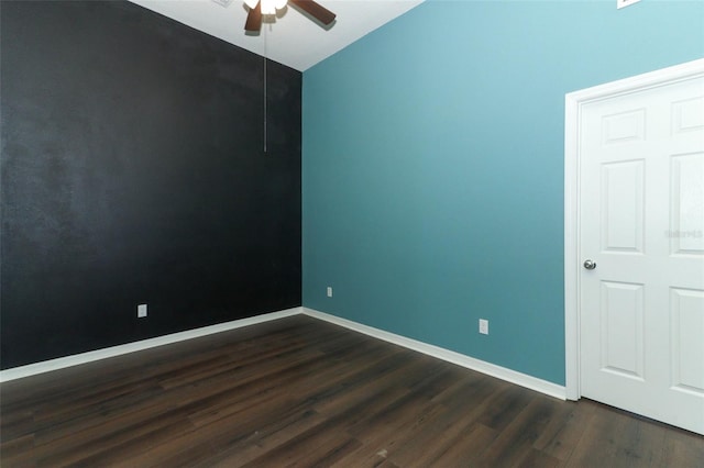 spare room featuring dark wood-type flooring, ceiling fan, and lofted ceiling