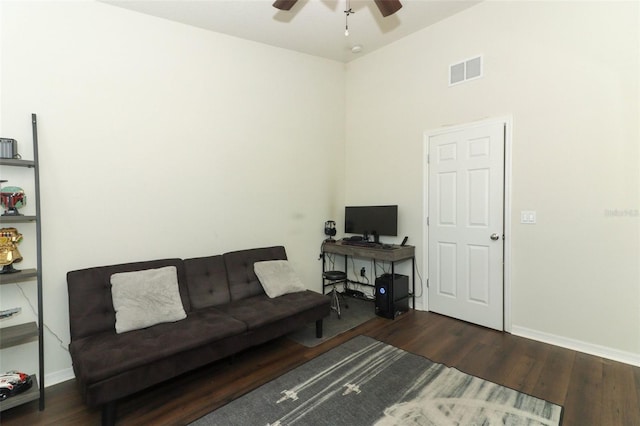 living room with ceiling fan and dark hardwood / wood-style flooring