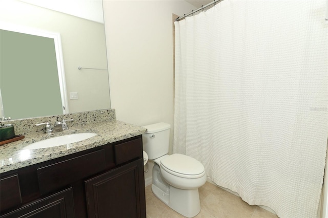 bathroom with vanity, tile patterned flooring, and toilet