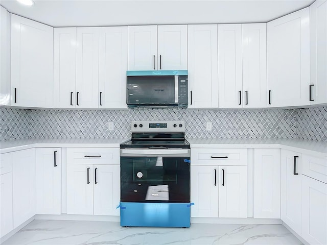 kitchen with white cabinetry, stainless steel appliances, and decorative backsplash