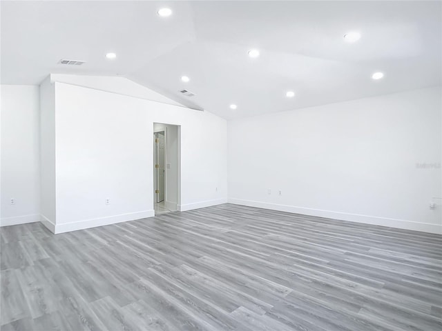 unfurnished room with vaulted ceiling and wood-type flooring