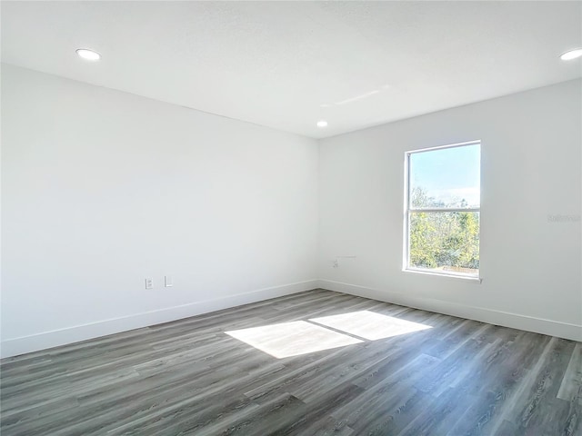 unfurnished room featuring dark wood-type flooring