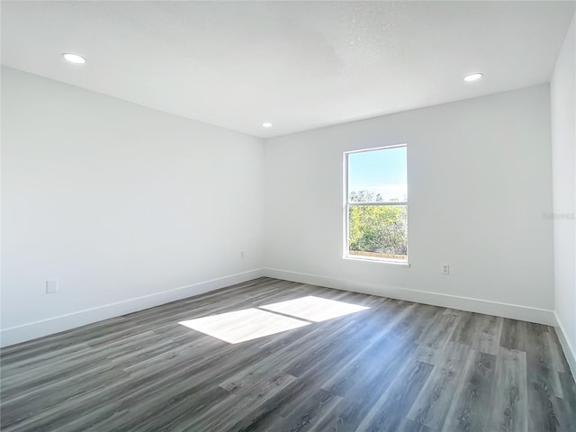 unfurnished room featuring dark wood-type flooring