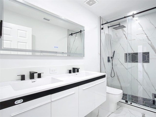 bathroom featuring toilet, vanity, and an enclosed shower