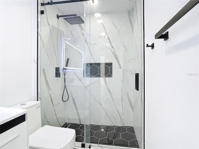 bathroom featuring toilet, an enclosed shower, and vanity