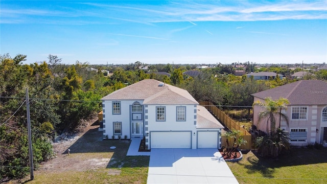 view of front of home with a front yard and a garage