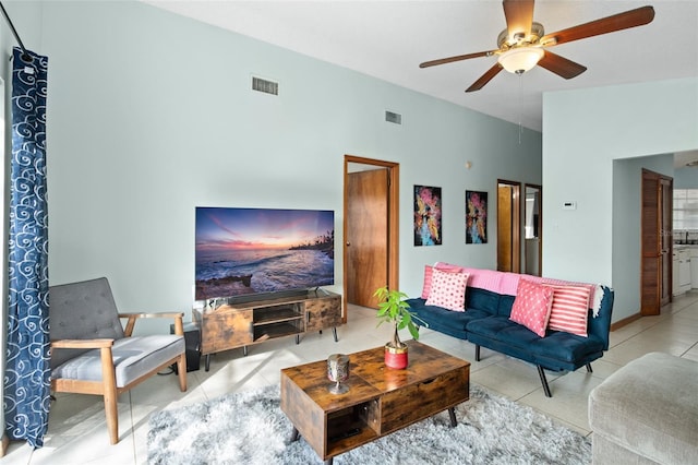 living room with ceiling fan and light tile patterned floors