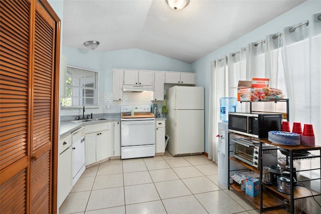 kitchen featuring light tile patterned flooring, sink, vaulted ceiling, white appliances, and white cabinets