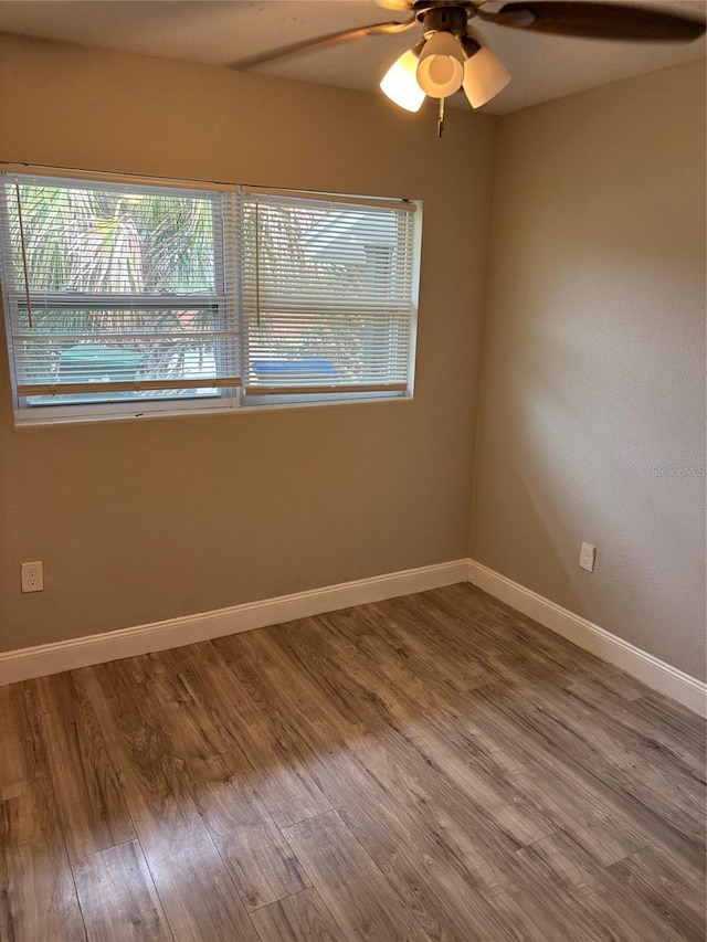 unfurnished room featuring hardwood / wood-style flooring and ceiling fan