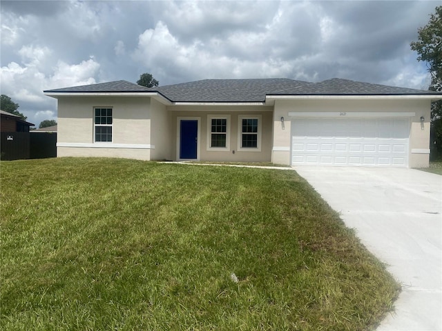 view of front of house with a garage and a front lawn