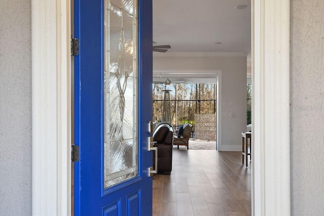 entryway featuring crown molding and ceiling fan