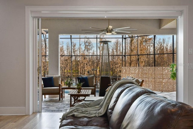 sunroom / solarium featuring ceiling fan