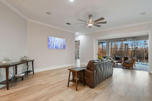 living room with ceiling fan, ornamental molding, and light wood-type flooring