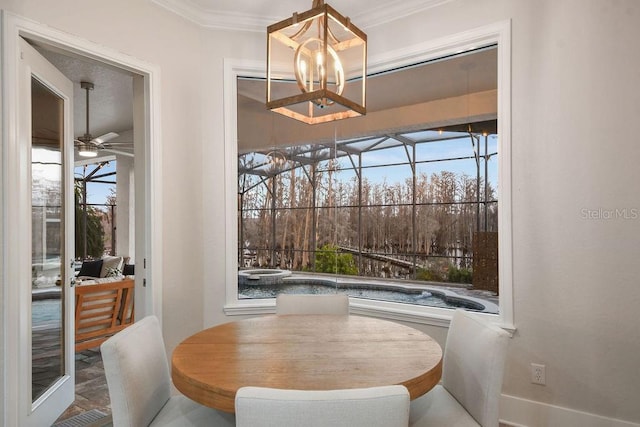 dining room with crown molding, ceiling fan with notable chandelier, and a wealth of natural light