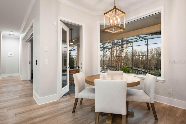 dining room with ceiling fan, ornamental molding, and hardwood / wood-style floors