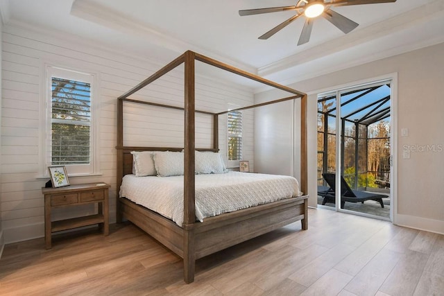 bedroom with multiple windows, access to exterior, and light hardwood / wood-style flooring