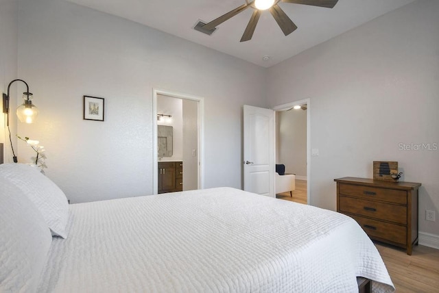 bedroom featuring light hardwood / wood-style flooring, ceiling fan, and ensuite bathroom