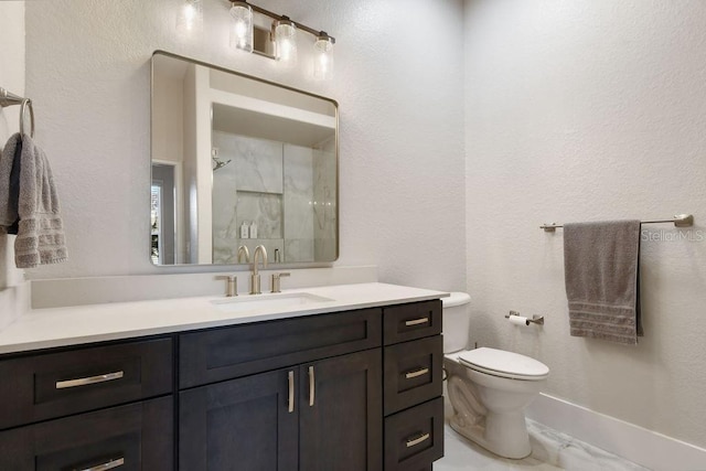 bathroom featuring vanity, toilet, and walk in shower