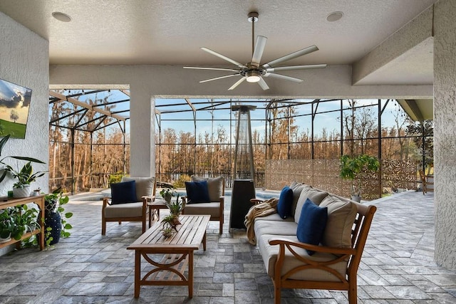 view of patio featuring ceiling fan, outdoor lounge area, and a lanai