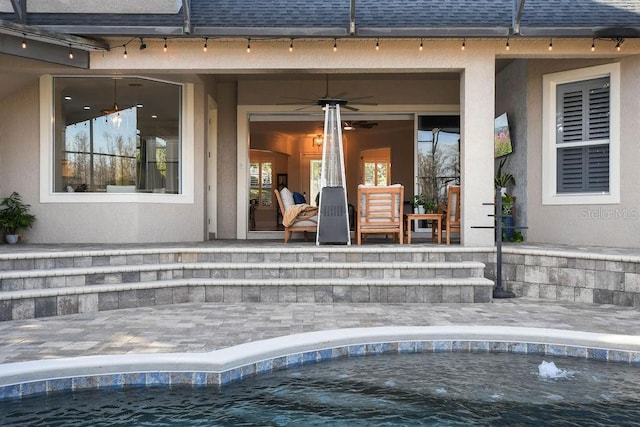 property entrance featuring a patio area and ceiling fan