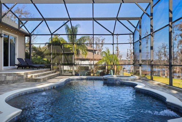 view of swimming pool featuring a lanai, a patio area, and an in ground hot tub