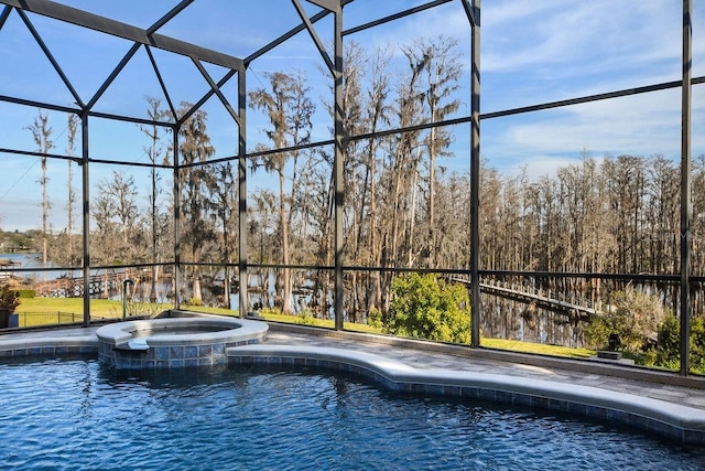 view of swimming pool with an in ground hot tub and glass enclosure