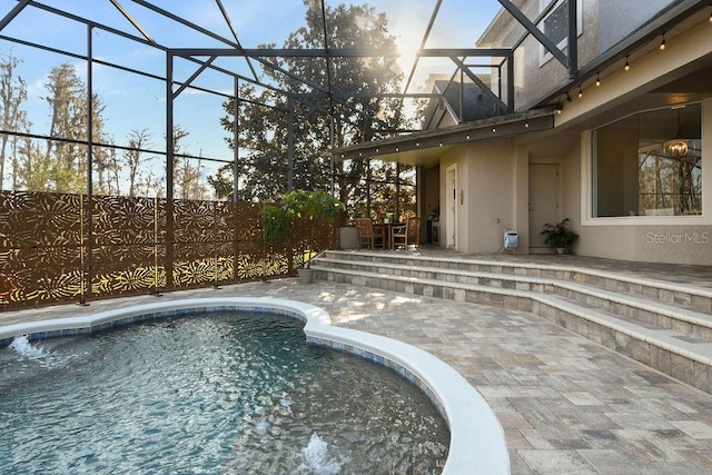 view of pool featuring a lanai and a patio