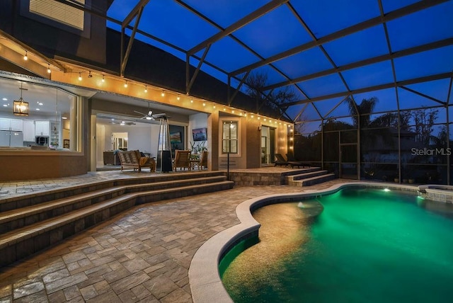 view of pool featuring a lanai, ceiling fan, and a patio area