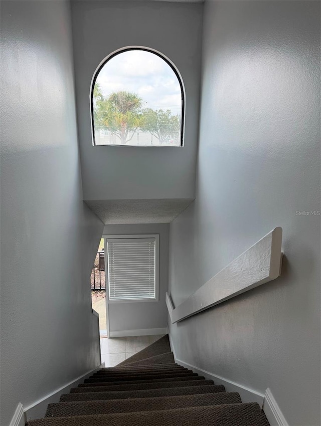 stairway with tile patterned floors