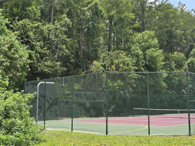 4826 Marks Ter Unit 389, Orlando, FL 32811 - view of tennis court with a view of trees