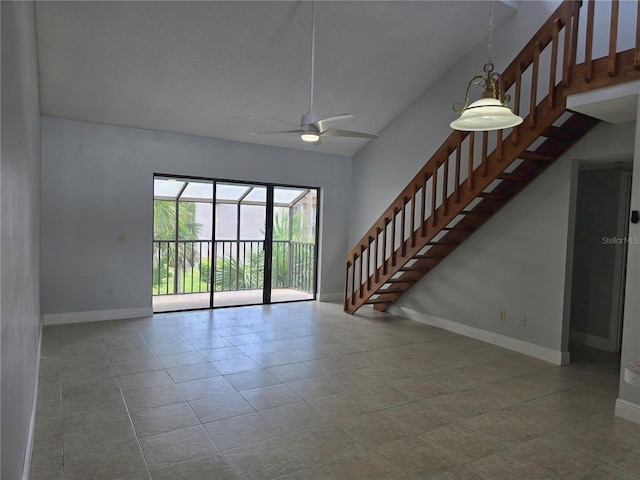 4826 Marks Ter Unit 389, Orlando, FL 32811 - unfurnished living room featuring stairway, ceiling fan, and tile patterned flooring