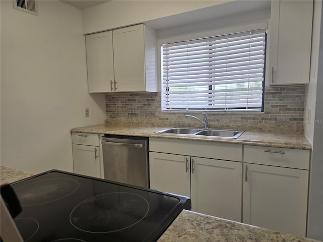 4826 Marks Ter Unit 389, Orlando, FL 32811 - kitchen featuring stainless steel dishwasher, tasteful backsplash, white cabinets, and light countertops