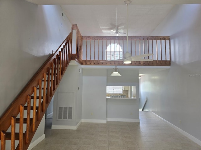 4826 Marks Ter Unit 389, Orlando, FL 32811 - staircase featuring ceiling fan, tile patterned flooring, and a towering ceiling