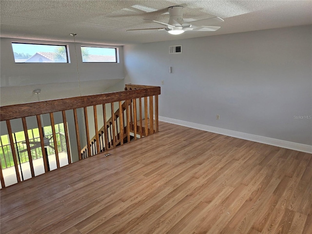 4826 Marks Ter Unit 389, Orlando, FL 32811 - spare room with wood finished floors, ceiling fan, and a textured ceiling