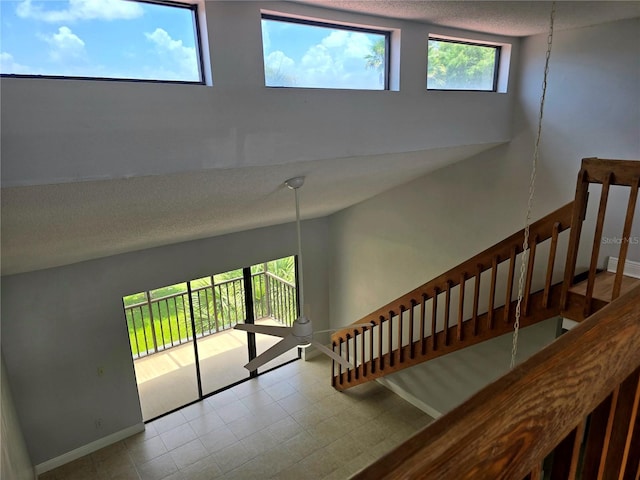4826 Marks Ter Unit 389, Orlando, FL 32811 - stairway with baseboards and a textured ceiling
