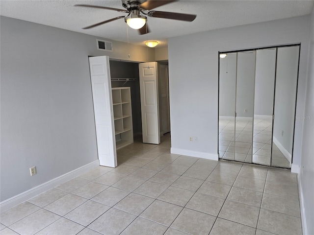4826 Marks Ter Unit 389, Orlando, FL 32811 - unfurnished bedroom with light tile patterned flooring, a textured ceiling, and a ceiling fan