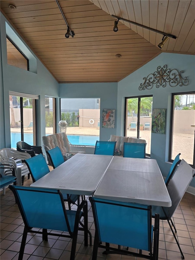 4826 Marks Ter Unit 389, Orlando, FL 32811 - dining area featuring track lighting, lofted ceiling, wooden ceiling, and tile patterned floors