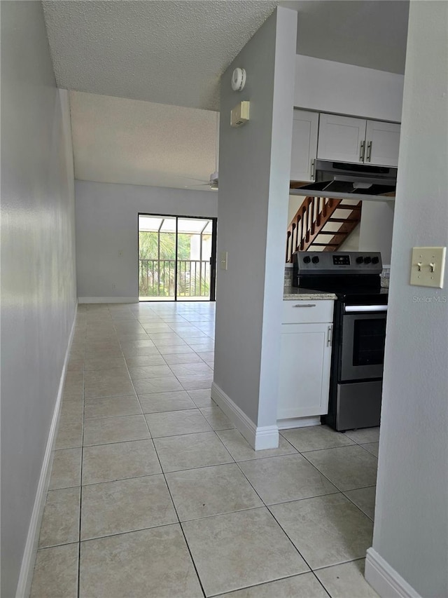 4826 Marks Ter Unit 389, Orlando, FL 32811 - corridor featuring light tile patterned floors and a textured ceiling